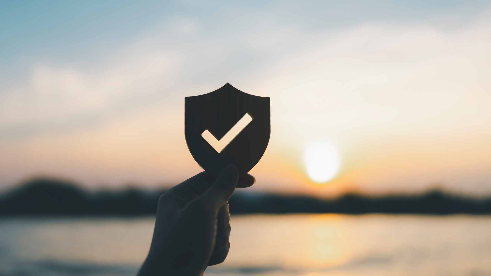 Businessman holding shield protect icon, Security protection and health insurance. The concept of family home, foster care, homeless support, protection, health care day.